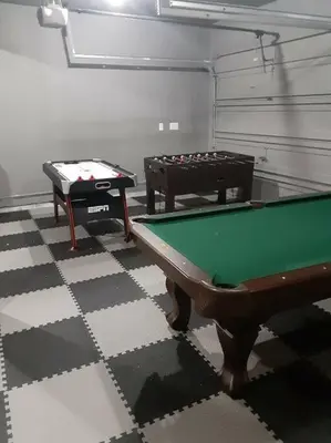 two pool tables in a room with a checkered floor at Stunning Lakefront Home - Swim, Fish, Kayak, HotTub in Long Pond