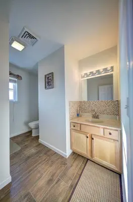 a bathroom with a sink and a toilet at Stunning Lakefront Home - Swim, Fish, Kayak, HotTub in Long Pond