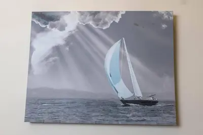 a sailboat in the ocean with a ray of sunlight at Hoboken Haven – Heart of town! in Hoboken