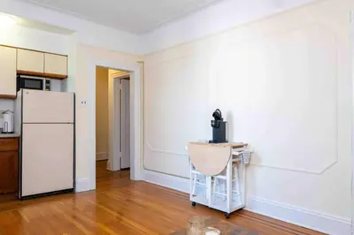 a kitchen with a refrigerator and a chair in a room at Spacious Oasis - Hoboken California King Bed! in Hoboken