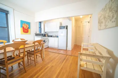 a kitchen and dining room with a table and chairs at Cozy apartment in beautiful midtown Hoboken in Hoboken