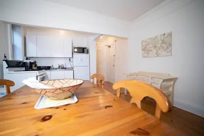 a kitchen with a wooden table with a bowl on it at Cozy apartment in beautiful midtown Hoboken in Hoboken