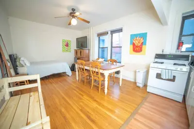 a kitchen and dining room with a table and chairs at Cozy apartment in beautiful midtown Hoboken in Hoboken