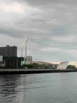 a view of a river with a building in the background at Studio by New York Harbor in Saint George