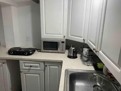 a kitchen with a sink and a microwave at Studio by New York Harbor in Saint George