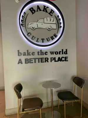 a sign on a wall with two chairs and a table at Studio by New York Harbor in Saint George