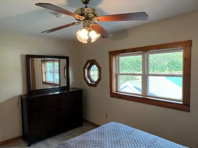 a bedroom with a ceiling fan and a dresser and a mirror at Wellsboro Rail Trail 1 in Wellsboro