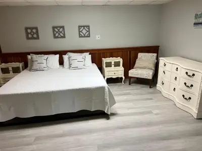 a bedroom with a white bed and two dressers at Wellsboro Rail Trail 1 in Wellsboro