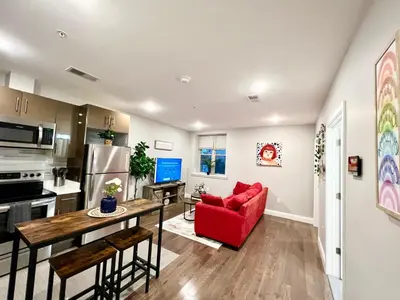 a kitchen and living room with a red couch at 304Stunning and comfy 1BDR APT in Center city in Philadelphia