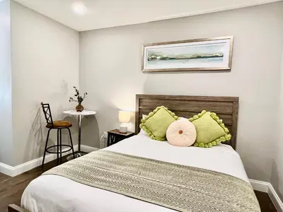 a bedroom with a bed with green pillows at 304Stunning and comfy 1BDR APT in Center city in Philadelphia