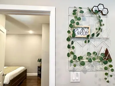 a plant on a wall next to a bedroom at 304Stunning and comfy 1BDR APT in Center city in Philadelphia