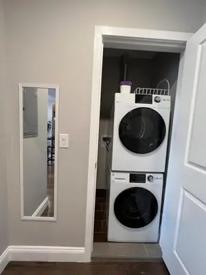 a microwave sitting on top of a washer and dryer at 304Stunning and comfy 1BDR APT in Center city in Philadelphia
