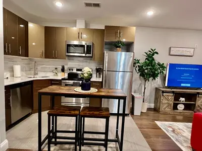 a kitchen with a table and a stainless steel refrigerator at 304Stunning and comfy 1BDR APT in Center city in Philadelphia