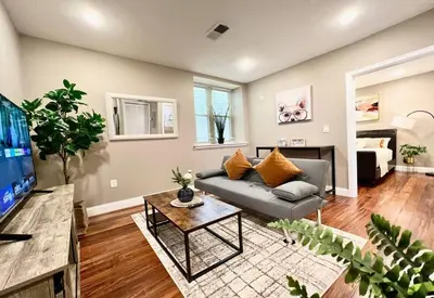 a living room with a couch and a tv at 405 Spacious and superior 1BDR APT in center city in Philadelphia