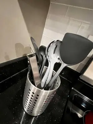 a cup filled with utensils on a kitchen counter at 405 Spacious and superior 1BDR APT in center city in Philadelphia