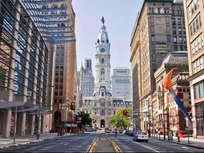 a city street with a building with a clock tower at 405 Spacious and superior 1BDR APT in center city in Philadelphia