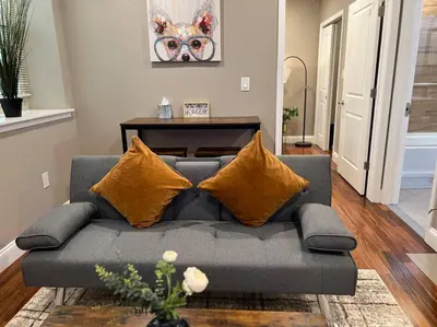 a living room with a gray couch with yellow pillows at 405 Spacious and superior 1BDR APT in center city in Philadelphia