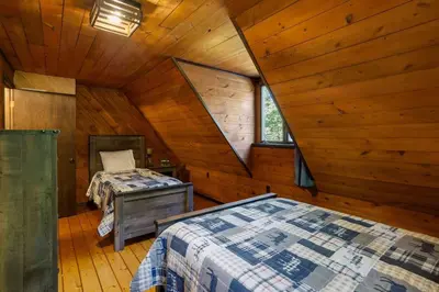 a bedroom with two beds in a log cabin at Rustic Luxury in the Pocono Mountains - Stag Lodge in Pocono Lake