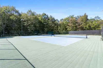 a tennis court with two tennis rackets on it at Rustic Luxury in the Pocono Mountains - Stag Lodge in Pocono Lake