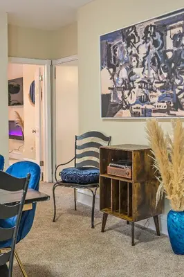 a living room with a chair and a table at Chic 4BR Dwelling with Backyard in Philadelphia in Philadelphia