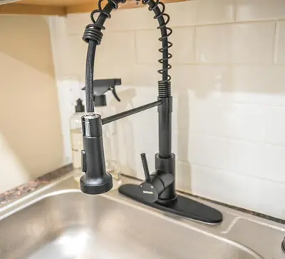 a kitchen sink with a faucet at Chic 4BR Dwelling with Backyard in Philadelphia in Philadelphia