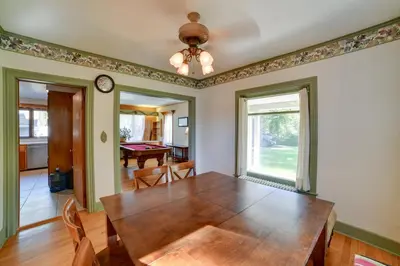 a dining room with a wooden table and a window at Rustic Bainbridge Retreat with Spacious Yard! in Bainbridge