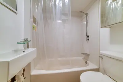 a bathroom with a shower and a toilet and a sink at Rustic Bainbridge Retreat with Spacious Yard! in Bainbridge