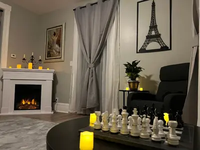 a living room with a chess board and the eiffel tower at Little France Phillipsburg in Phillipsburg