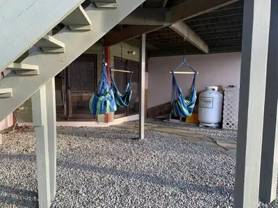 a porch with two blue hammocks hanging under a building at Magical Waterfront with 4-Season fun in Ski Resort in Lackawaxen