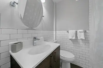 a bathroom with a sink and a toilet and a mirror at Avenue A821 I Cozy and Comfy Philadelphia stay in Philadelphia