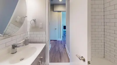 a white bathroom with a sink and a shower at Avenue B234 2Bedroom With Pool, Gym, Parking in Philadelphia