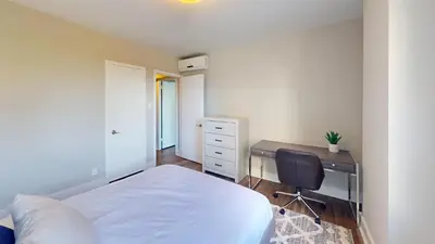 a bedroom with a desk and a bed and a chair at Avenue B234 2Bedroom With Pool, Gym, Parking in Philadelphia