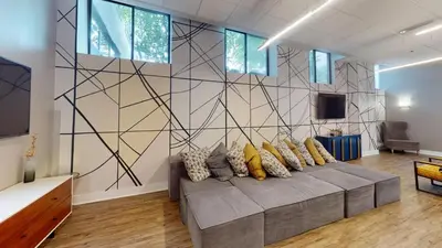 a living room with a couch with pillows on it at Avenue B234 2Bedroom With Pool, Gym, Parking in Philadelphia