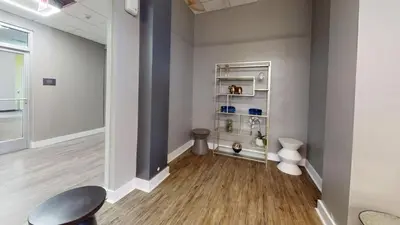 a hallway with a table and a chair in a room at Avenue B234 2Bedroom With Pool, Gym, Parking in Philadelphia