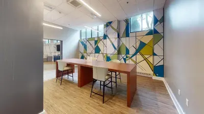 a conference room with a table and chairs and a mosaic wall at Avenue B234 2Bedroom With Pool, Gym, Parking in Philadelphia