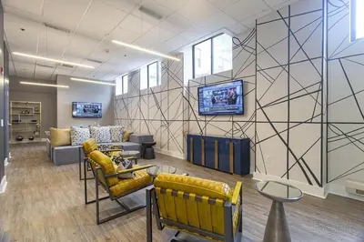 a waiting room with couches and a tv on a wall at Avenue B234 2Bedroom With Pool, Gym, Parking in Philadelphia