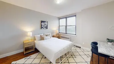 a white bedroom with a bed and a window at Avenue A909 Comfy 2Br, Pool, Gym, Parking in Philadelphia