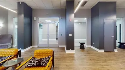 an empty room with two chairs and tables and doors at Avenue A909 Comfy 2Br, Pool, Gym, Parking in Philadelphia