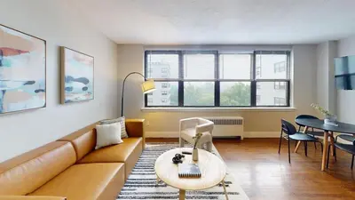 a living room with a couch and a table at Avenue A909 Comfy 2Br, Pool, Gym, Parking in Philadelphia