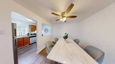 a dining room with a table and a ceiling fan at pb 1112 Furnished 2br with Parking, gym, in Newark