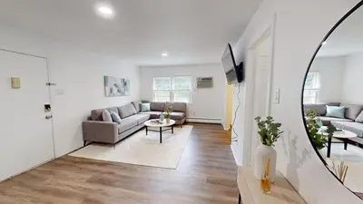 a living room with a couch and a table at pb 1112 Furnished 2br with Parking, gym, in Newark