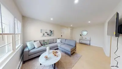 a living room with a couch and a table at Pine Brook 1322 I Pool Gym I Free Parking ! in Newark