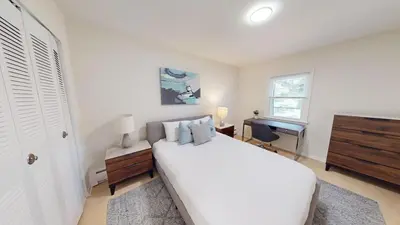 a white bedroom with a white bed and a desk at Pine Brook 1322 I Pool Gym I Free Parking ! in Newark