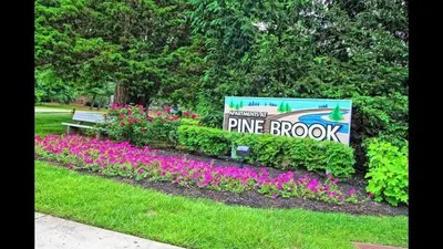 a sign for the entrance to a pine brook park at Pine Brook 1322 I Pool Gym I Free Parking ! in Newark