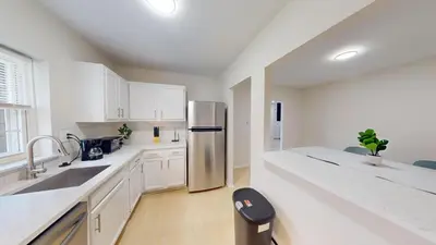 a kitchen with white cabinets and a stainless steel refrigerator at Pine Brook 1322 I Pool Gym I Free Parking ! in Newark