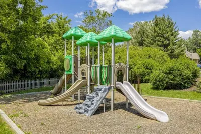 a playground with slides and umbrellas at Pine Brook 1322 I Pool Gym I Free Parking ! in Newark