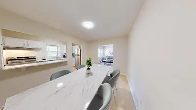 a dining room with a white table and chairs at Pine Brook 1322 I Pool Gym I Free Parking ! in Newark
