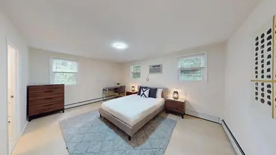 a bedroom with a bed and a dresser and windows at Pine Brook 804 I Pool Gym I Free Parking ! in Newark