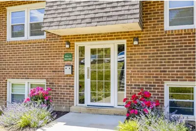 a brick house with white doors and flowers at Pine Brook 804 I Pool Gym I Free Parking ! in Newark