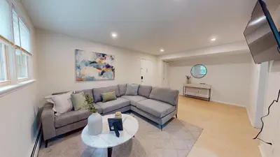 a living room with a couch and a table at Pine Brook 804 I Pool Gym I Free Parking ! in Newark